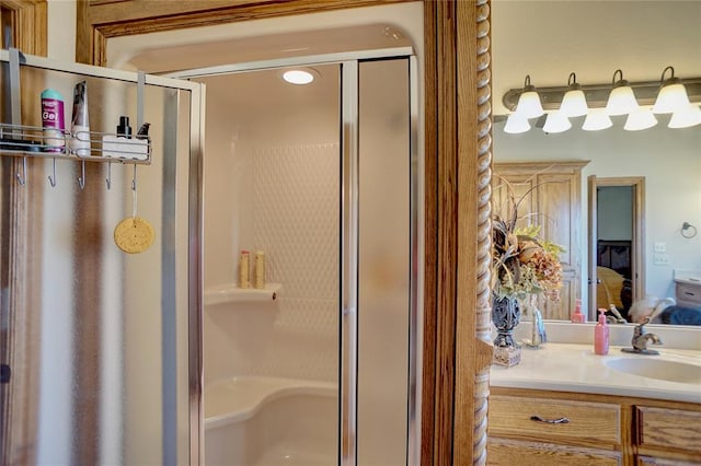 bathroom featuring vanity and a shower with door