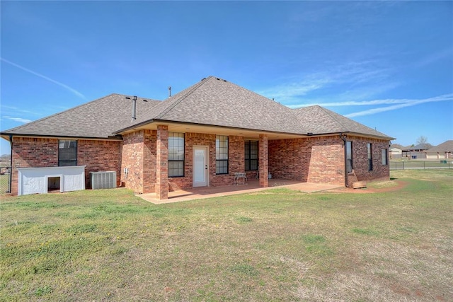 back of property featuring a lawn, cooling unit, and a patio area