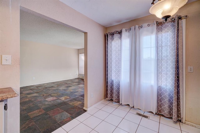 spare room featuring a textured ceiling