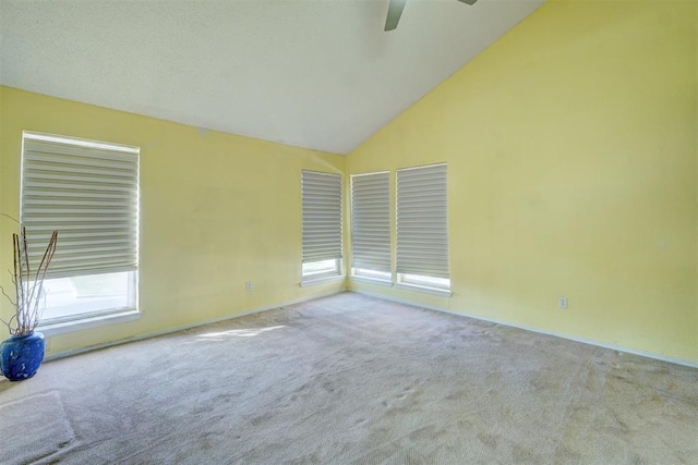 unfurnished room featuring ceiling fan, carpet, and high vaulted ceiling