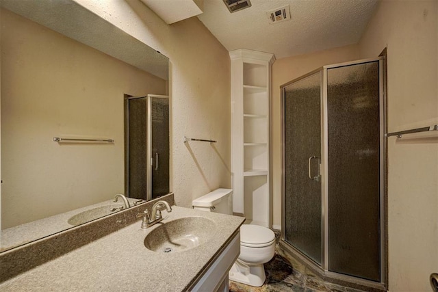 bathroom with vanity, toilet, a textured ceiling, and walk in shower