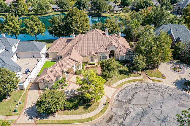 drone / aerial view with a water view and a residential view