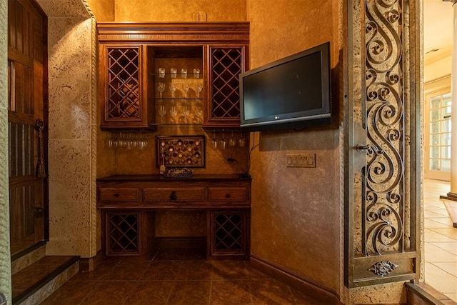 wine area with dark tile patterned floors