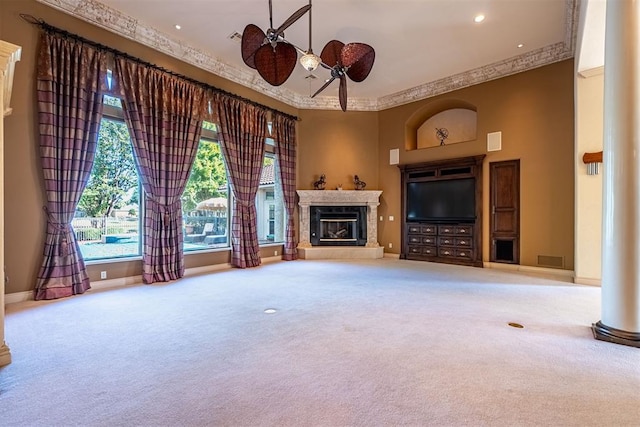 unfurnished living room featuring a ceiling fan, carpet, baseboards, and a premium fireplace