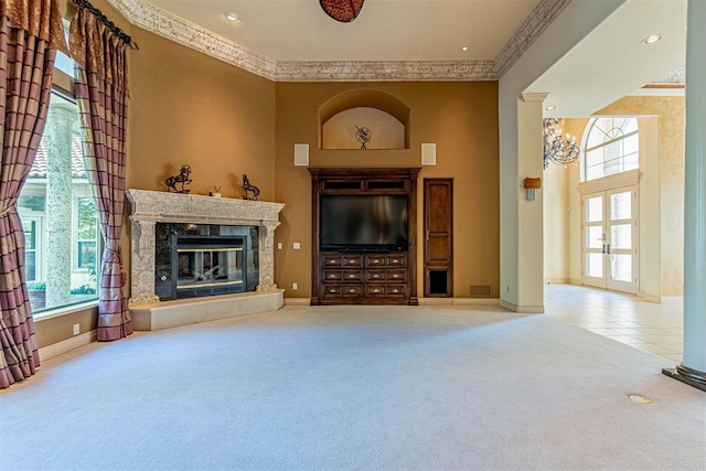 carpeted living area featuring baseboards, ornamental molding, and a high end fireplace