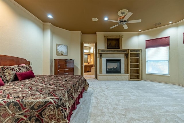 bedroom with recessed lighting, carpet flooring, visible vents, ornamental molding, and a glass covered fireplace