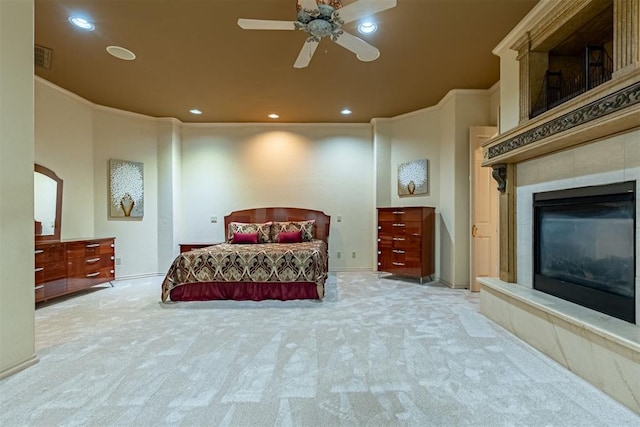 bedroom with carpet floors, arched walkways, recessed lighting, a tiled fireplace, and ornamental molding