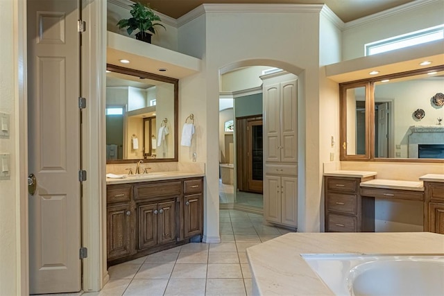 bathroom with ornamental molding, vanity, a high ceiling, and tile patterned floors