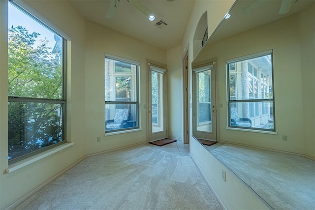 interior space featuring carpet floors, visible vents, and a ceiling fan