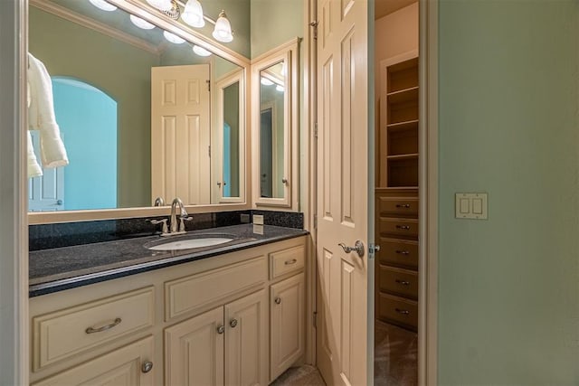 bathroom featuring crown molding and vanity