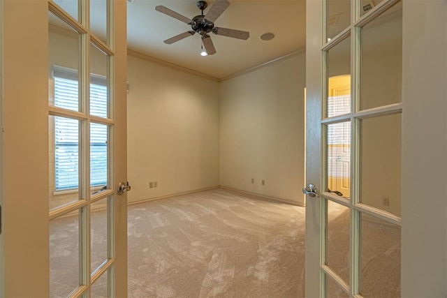 unfurnished room with ceiling fan, carpet flooring, baseboards, french doors, and crown molding