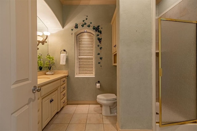 bathroom featuring tile patterned flooring, toilet, a shower stall, and vanity