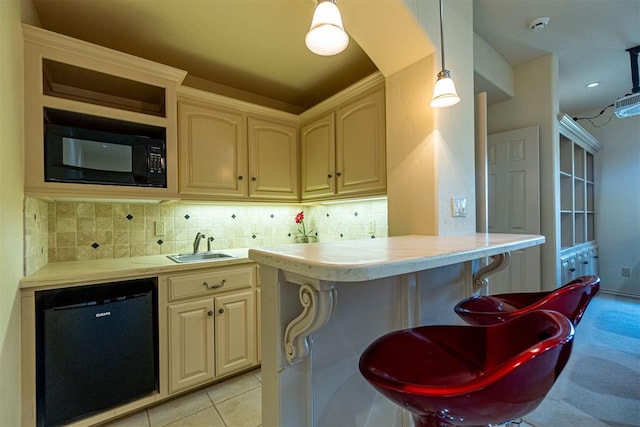 bar featuring light tile patterned floors, tasteful backsplash, a sink, black microwave, and dishwasher