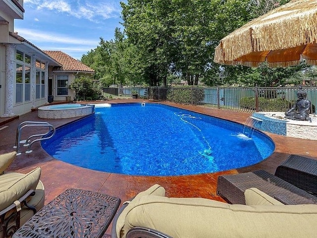 view of pool featuring a fenced in pool, a fenced backyard, a patio, and an in ground hot tub