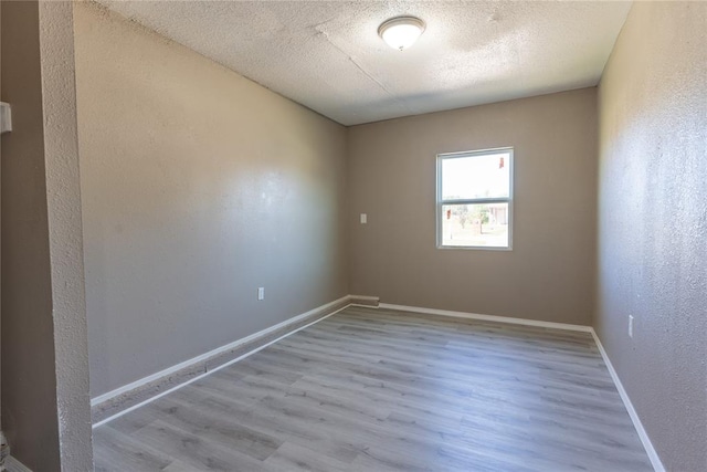 spare room featuring light hardwood / wood-style flooring