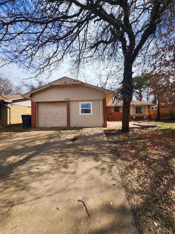 5300 Creekwood Ter, Oklahoma City, OK 73135 - view of front facade featuring concrete driveway, brick siding, and a garage