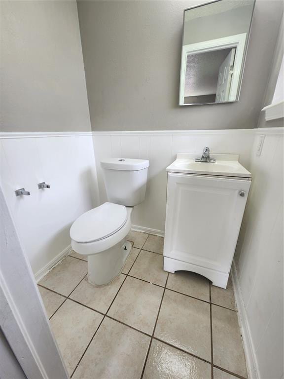 bathroom featuring tile patterned flooring, vanity, and toilet