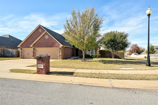 view of front of home with a garage and a front lawn