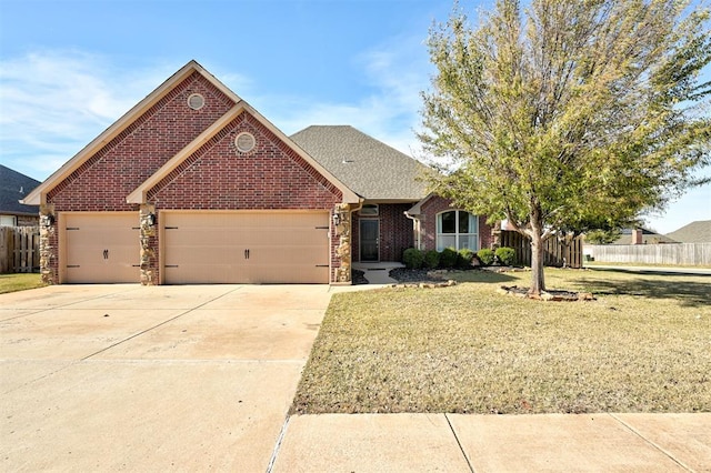 view of front of house with a front yard and a garage