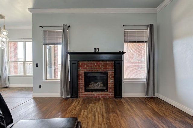 unfurnished living room featuring a fireplace, ornamental molding, dark wood-type flooring, and a healthy amount of sunlight