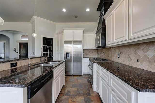 kitchen featuring sink, pendant lighting, a kitchen island with sink, white cabinets, and appliances with stainless steel finishes