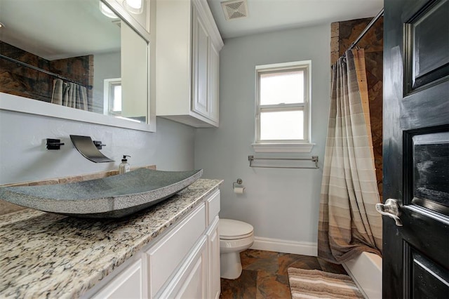 full bathroom featuring vanity, toilet, and shower / tub combo