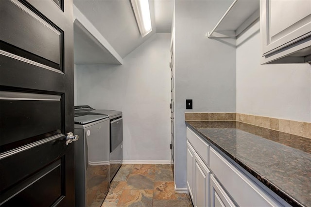 laundry area with washer and clothes dryer and cabinets