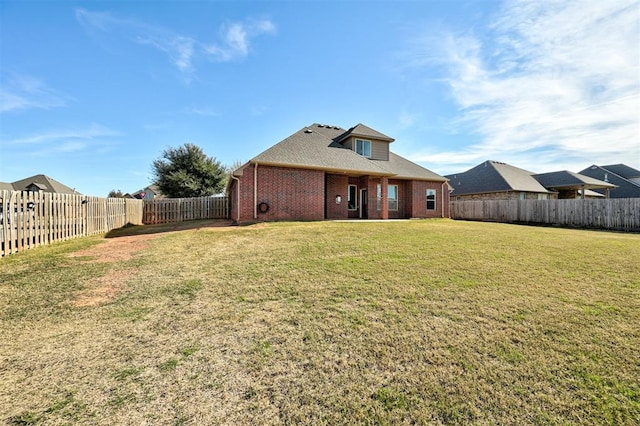 rear view of house with a yard