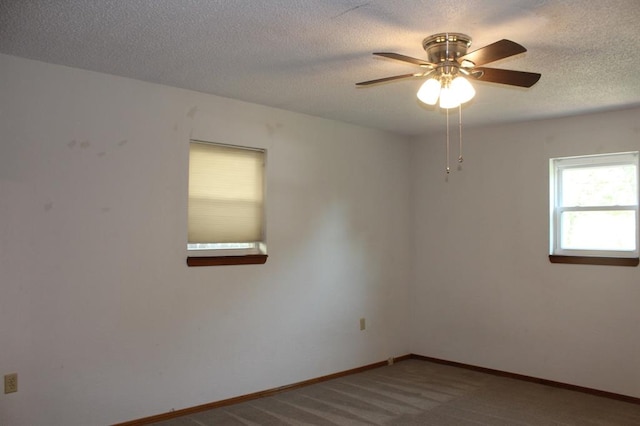 carpeted spare room with ceiling fan and a textured ceiling