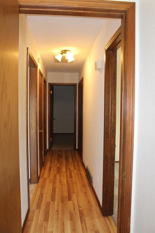 corridor featuring light wood-type flooring