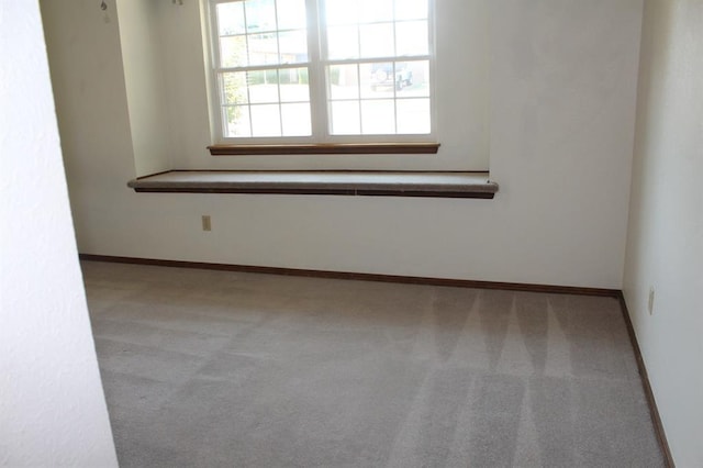 unfurnished room with light colored carpet