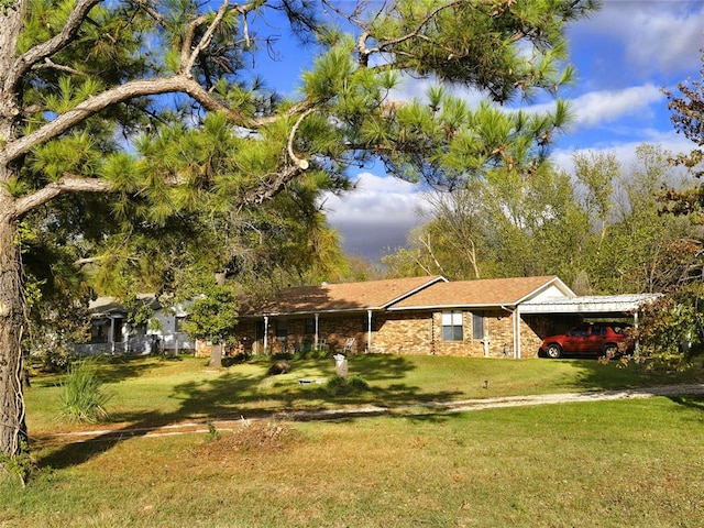 view of front of home with a front lawn and a carport