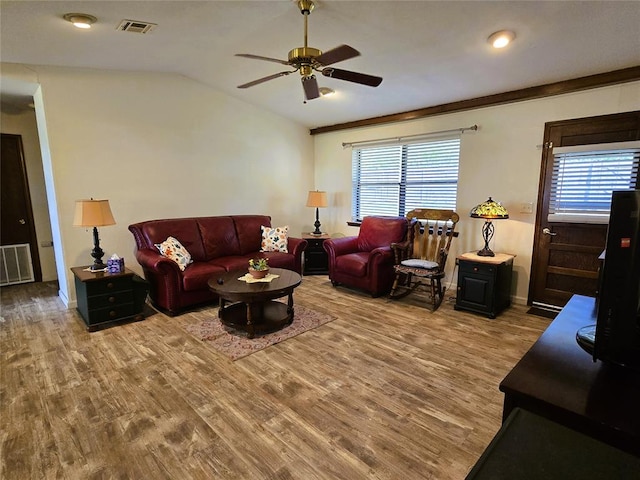 living room featuring hardwood / wood-style flooring, a wealth of natural light, and vaulted ceiling