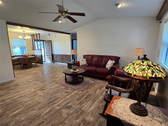 living room featuring ceiling fan with notable chandelier, lofted ceiling, and hardwood / wood-style flooring