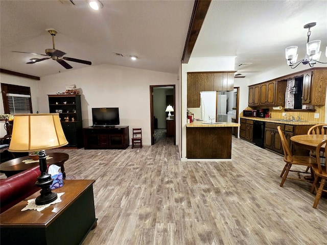 living room featuring lofted ceiling with beams, sink, light hardwood / wood-style floors, and ceiling fan with notable chandelier