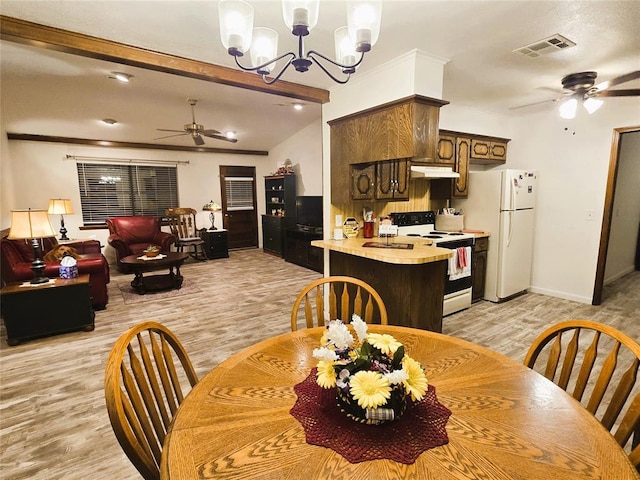 dining space with light hardwood / wood-style flooring, ceiling fan with notable chandelier, and lofted ceiling