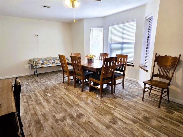 dining room featuring wood-type flooring and ceiling fan