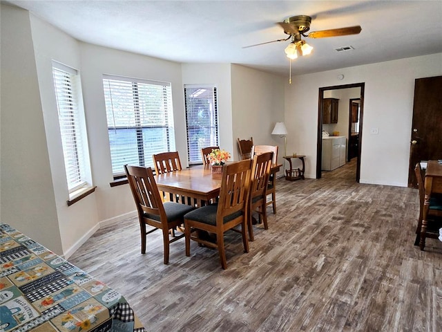 dining room featuring ceiling fan, hardwood / wood-style floors, and washer / dryer