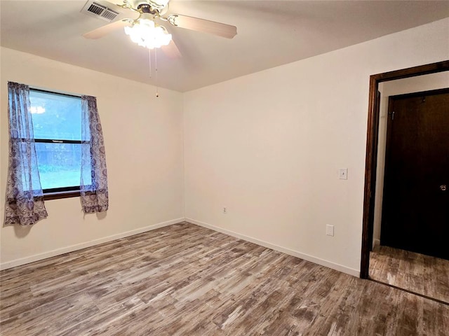 unfurnished room featuring hardwood / wood-style floors and ceiling fan