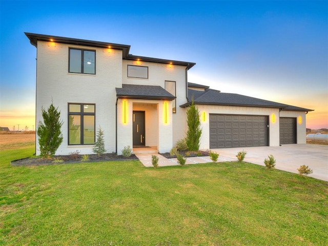 view of front of house with a lawn and a garage