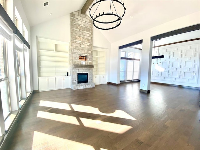 unfurnished living room with built in shelves, beam ceiling, high vaulted ceiling, a fireplace, and dark hardwood / wood-style floors