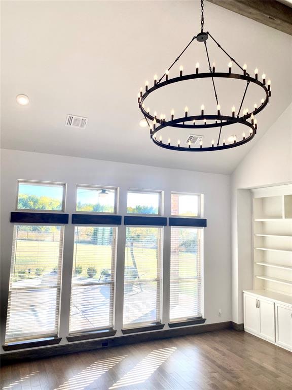 interior space featuring hardwood / wood-style floors, lofted ceiling with beams, and a notable chandelier