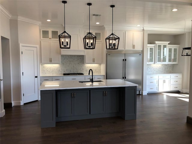 kitchen featuring built in fridge, dark hardwood / wood-style flooring, white cabinets, and decorative light fixtures