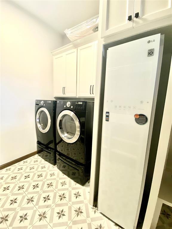 laundry room featuring cabinets and separate washer and dryer