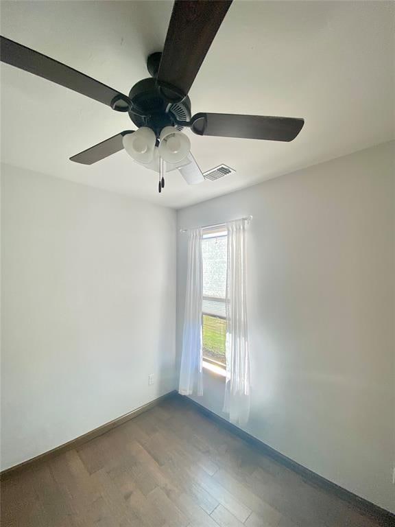 unfurnished room with hardwood / wood-style floors and ceiling fan