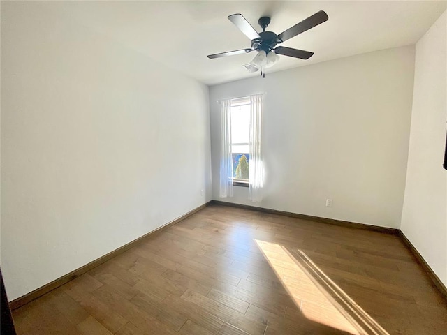 empty room featuring ceiling fan and hardwood / wood-style floors