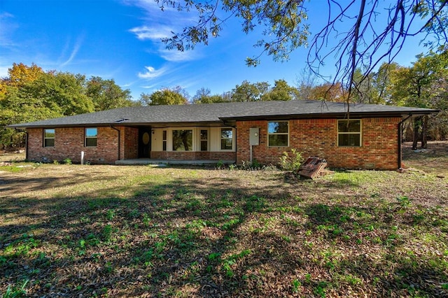 ranch-style house with brick siding and a front lawn