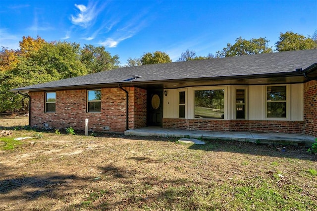 ranch-style house with a patio area, brick siding, crawl space, and a shingled roof