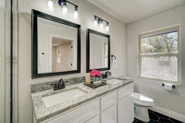 bathroom featuring tile patterned floors, vanity, and toilet