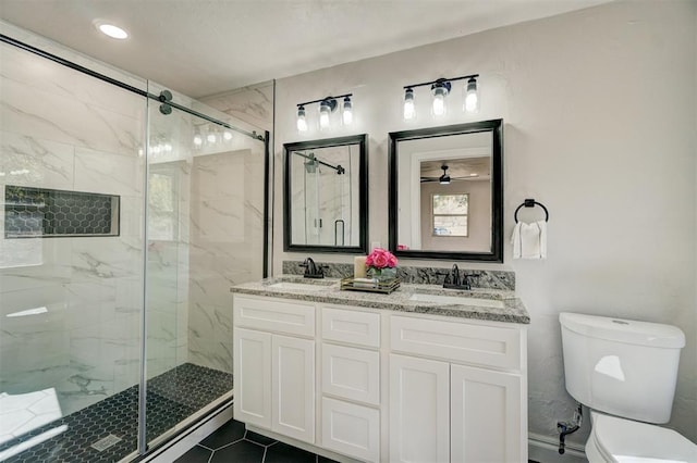 bathroom featuring an enclosed shower, vanity, ceiling fan, tile patterned flooring, and toilet